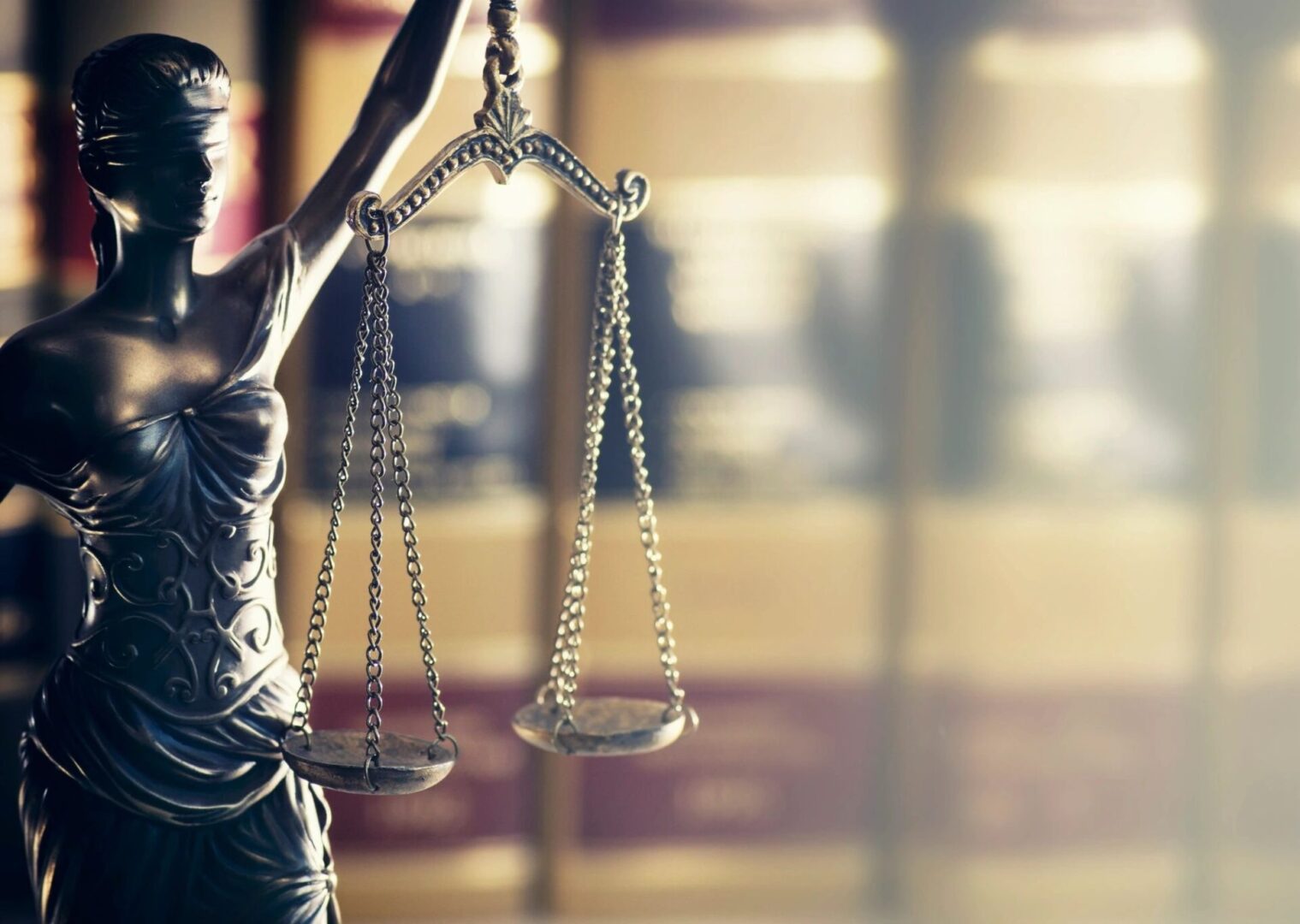 Lady Justice statue holding scales symbolizing fairness and law.